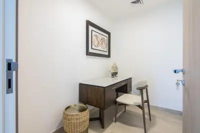 a desk and a chair in a room at Me Do Re1BR, JLT in Dubai