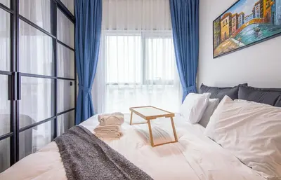a room with a bed with a table on it at Collective 1,0 Dubai Hills- Cozy 1-BR in Dubai