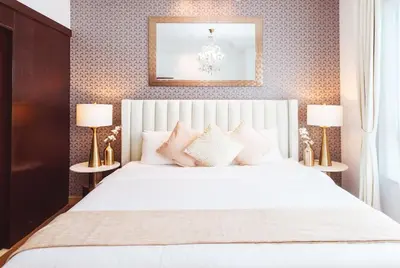 a bedroom with a white bed with two lamps at Elite Royal Apartment - Sky Series - Full Burj Khalifa & Fountain View - Chancellor in Dubai