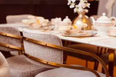 a long table with chairs and plates on it at Elite Royal Apartment - Sky Series - Full Burj Khalifa & Fountain View - Chancellor in Dubai