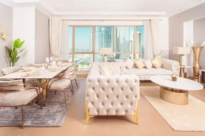 a living room with a white couch and a table at Elite Royal Apartment - Sky Series - Full Burj Khalifa & Fountain View - Chancellor in Dubai