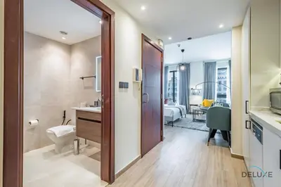 a bathroom with a toilet and a sink at Exclusive Promo Luxe 1BR at a Special Price by Deluxe Holiday Homes in Dubai