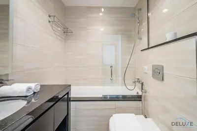 a bathroom with a sink and a shower at Cosmopolitan 1BR Apartment in Celestia B, Dubai South by Deluxe Holiday Homes in Dubai