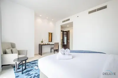 a hotel room with a bed and a living room at Cosmopolitan 1BR Apartment in Celestia B, Dubai South by Deluxe Holiday Homes in Dubai