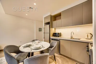 a kitchen and dining room with a table and chairs at Creek Gate by Emaar, Dubai Creek Harbour in Dubai