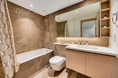 a bathroom with a tub and a toilet and a sink at Creek Gate by Emaar, Dubai Creek Harbour in Dubai