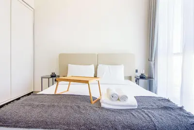 a bedroom with a bed with towels on it at Collective 2,0 Dubai Hills- Attractive 1-BR in Dubai