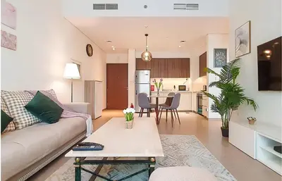 a living room with a couch and a table at Park Heights, Dubai Hills- Cozy 1-BR in Dubai