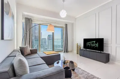 a living room with a couch and a tv at Prival - Marina & Sea View in Dubai