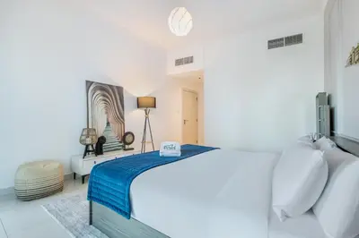 a white bedroom with a bed in a room at Prival - Marina & Sea View in Dubai