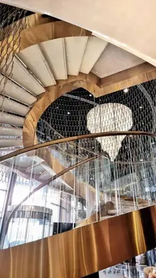 a spiral staircase in a building with an apple sculpture at 1 Bedroom Apartment Paramount in Dubai