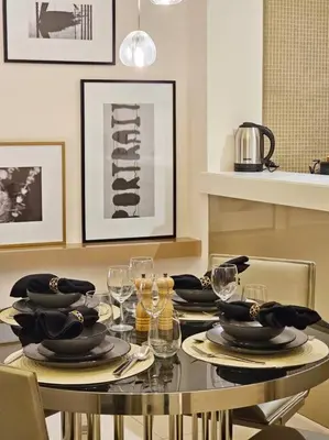 a dining room table with plates and wine glasses at 1 Bedroom Apartment Paramount in Dubai