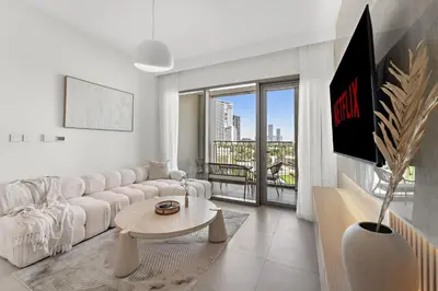 a living room with a white couch and a table at Chic 1BR Retreat - Near Burj Khalifa & Dubai Mall in Dubai