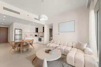 a living room with a white couch and a table at Chic 1BR Retreat - Near Burj Khalifa & Dubai Mall in Dubai