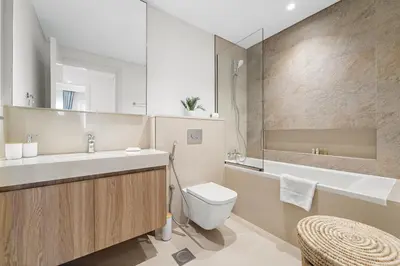a bathroom with a sink and a toilet and a tub at Chic 1BR Retreat - Near Burj Khalifa & Dubai Mall in Dubai