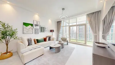 a living room with white furniture and large windows at Marinascape Oceanic - Luxurious Two Bedroom in Dubai