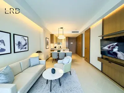 a living room with a couch and a table at Luxurious 2BR The Address Opera in Dubai