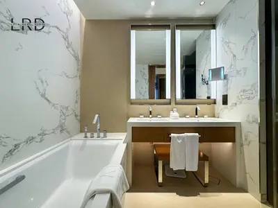 a bathroom with a tub and a sink at Luxurious 2BR The Address Opera in Dubai