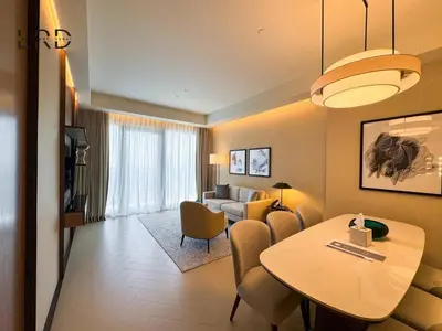 a living room with a table and a couch at Luxurious 2BR The Address Opera in Dubai