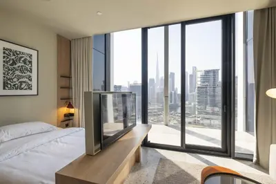 a bedroom with a bed and a large window at Modern Studio at Upside Living, Business Bay with Burj Khalifa View in Dubai