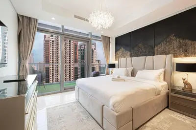 a bedroom with a large bed and a large window at Panoramic Burj Khalifa views-64th floor infinity pool in Dubai
