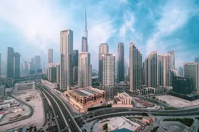 an aerial view of a city with tall buildings at Panoramic Burj Khalifa views-64th floor infinity pool in Dubai