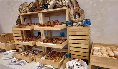 a shelf filled with lots of different types of donuts at Panoramic Burj Khalifa views-64th floor infinity pool in Dubai