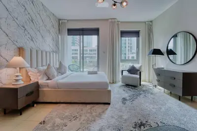 a bedroom with a large bed and a mirror at Stunning Luxury Studio Downtown 2 Minute Walk to Burj Khalifa & Dubai Mall in Dubai