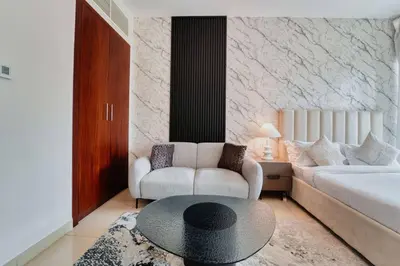 a living room with a couch and a table at Stunning Luxury Studio Downtown 2 Minute Walk to Burj Khalifa & Dubai Mall in Dubai