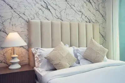 a bedroom with a bed with white pillows at Stunning Luxury Studio Downtown 2 Minute Walk to Burj Khalifa & Dubai Mall in Dubai