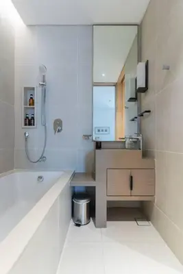 a bathroom with a tub and a sink and a mirror at Address JBR l Beachfront l Mid floor & opened view in Dubai