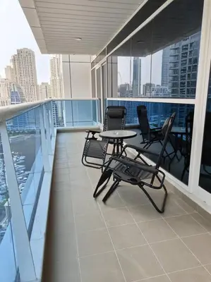 a balcony with chairs and a table on a building at Large 1BR with Great View in Dubai