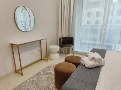 a living room with a couch and a mirror at Large 1BR with Great View in Dubai