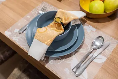 a table with a plate with a napkin and a bowl of apples at Luxury 1 bedroom apartment in JBR with Beach access in Dubai