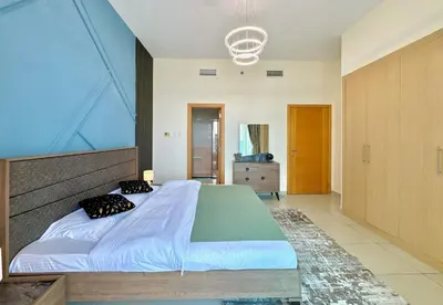 a bedroom with a large bed with a large window at Skyline View Premium Apartment in Dubai