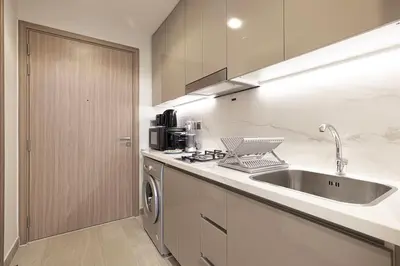 a kitchen with a sink and a dishwasher at Elegant Studio with Terrace 7 min Burj Khalifa in Dubai