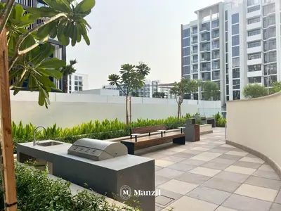 a park with two benches and a computer on it at Manzil - Studio Apartment in Azizi Riviera near Dubai Mall in Dubai