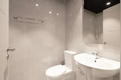 a white bathroom with a toilet and a sink at Kabene Exotic, Burj Khalifa & Fountain View, 5 Starts, 4 Bedroom, Best In Dubai in Dubai