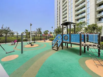 a playground with a slide and swings at FIRST CLASS Studio Luxe Living in Dubai