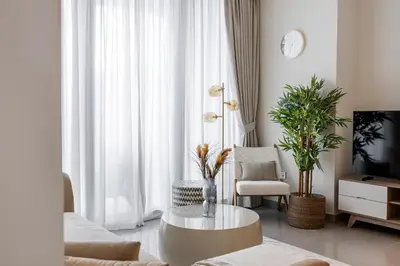 a living room with a coffee table and a tv at 1BR Forte II Downtown View in Dubai