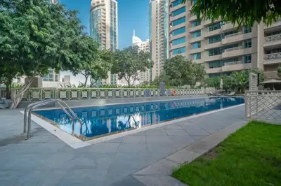 a swimming pool in a city with tall buildings at Bellavista - 29 BLVD - 1 Bedroom Burj Khalifa & Fountain View in Dubai