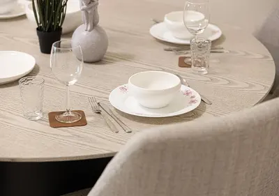 a table with white plates and glasses on a table at lux 2BD in heart of Downtown, 2 Mins Walk to Dubai Mall - Burj al Nujoom in Dubai