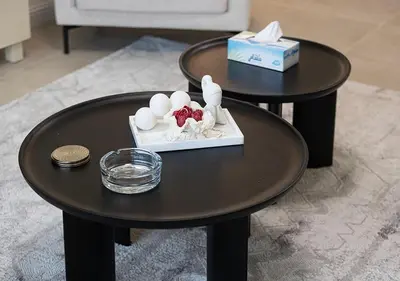 two black tables with nesting tables with eggs and a box at lux 2BD in heart of Downtown, 2 Mins Walk to Dubai Mall - Burj al Nujoom in Dubai