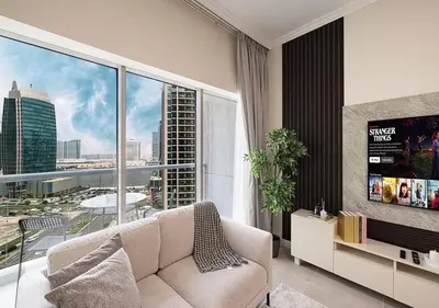 a living room with a couch and a large window at lux 2BD in heart of Downtown, 2 Mins Walk to Dubai Mall - Burj al Nujoom in Dubai