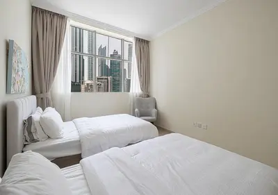 a hotel room with two beds and a window at lux 2BD in heart of Downtown, 2 Mins Walk to Dubai Mall - Burj al Nujoom in Dubai