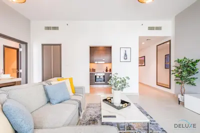 a living room with a couch and a table at Charming 1BR Apartment in Downtown Views 1, Downtown Dubai by Deluxe Holiday Homes in Dubai