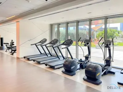 a gym with treadmills and elliptical machines at Charming 1BR Apartment in Downtown Views 1, Downtown Dubai by Deluxe Holiday Homes in Dubai