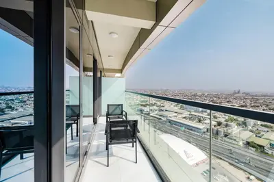 a balcony with chairs and a view of the city at ALiving Charming 1BR I Aykon City Tower, Business Bay in Dubai