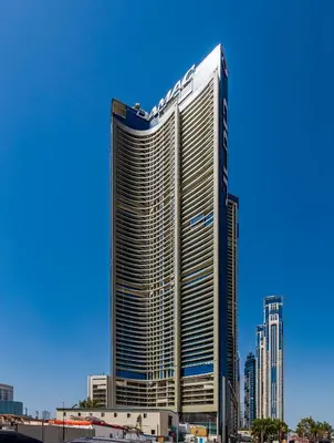 a tall building with a sign on the side of it at ALiving Charming 1BR I Aykon City Tower, Business Bay in Dubai