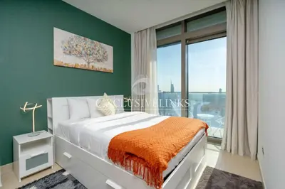 a bedroom with a bed and a large window at Stunning 1Bed High Floor Marina View in Dubai